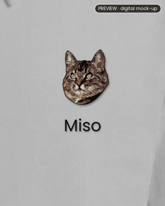 Preview: an embroidered tabby cat's head on the left chest of a grey melange hoodie, with the name Miso stitched in black